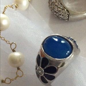 featuring a blue cabochon and enamel flowers ring